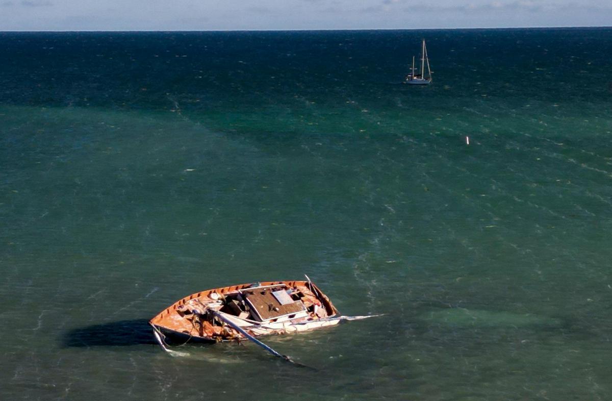 A vessel used by Haitian migrants to trace to the United States sits stuck in a sandbar off the coast of Islamorada in the Florida Keys on Jan. 14, 2023.