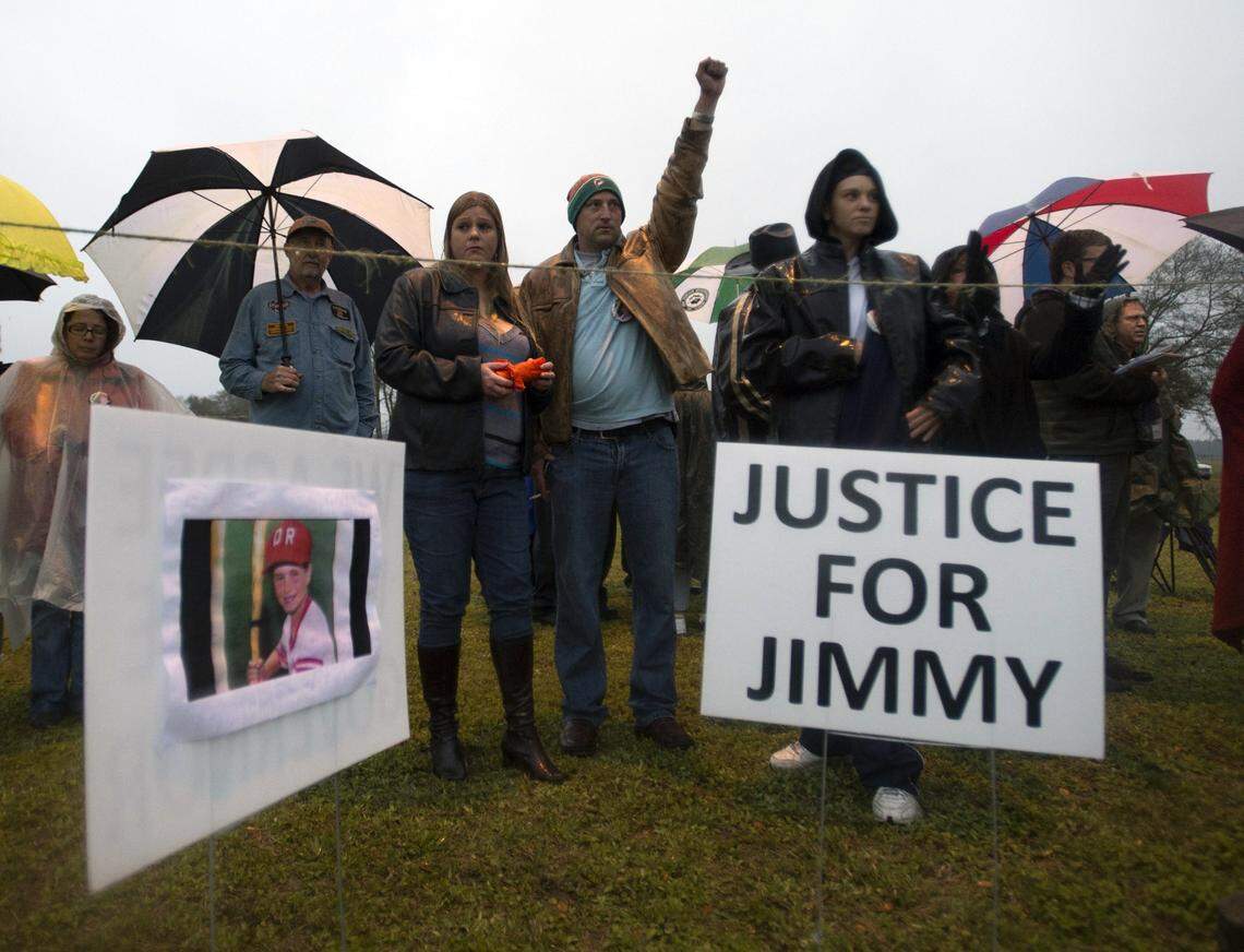 Tim Nowak throws up his arm at the time of the scheduled execution of Juan Carlos Chavez as friends of Jimmy Ryce maintain a vigil across the highway from the Florida State Correctional Prison near Starke, Fla. Wednesday, Feb. 12, 2014. Chavez was executed Wednesday night for raping and killing 9-year-old boy Jimmy Ryce 18 years ago, a death that spurred the victim’s parents to press nationwide for stronger sexual predator confinement laws and better handling of child abduction cases.