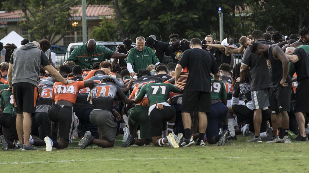University of Miami coach Mark Richt huddles with football recruits who visited the University of Miami’s campus in Coral Cables for the third annual Paradise Camp on Saturday, July 28, 2018.