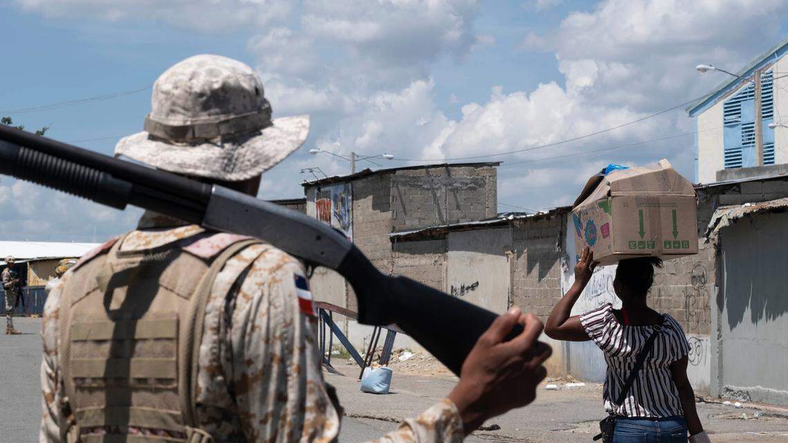 A Dominican Republic soldier stands on the border bridge between Dajabon, Dominican Republic, and Haiti. The bridge is closed because of a dispute over water rights between the two countries.