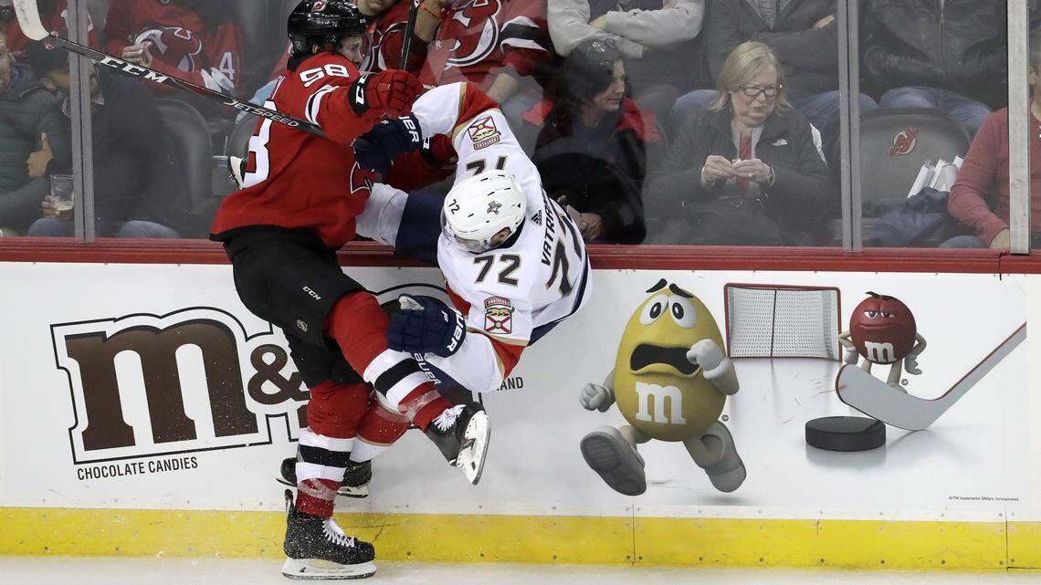 New Jersey Devils center Kevin Rooney, left, checks Florida Panthers center Frank Vatrano during the third period of an NHL hockey game, Saturday, Oct. 27, 2018, in Newark, N.J. The Devils won 3-2.