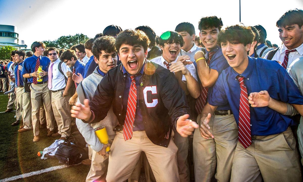 Columbus High School students react after after Marcus Lemonis announcing his surprise donation of $10 million to build two centers and to cover $18,000 checks for all employees at his Miami alma mater, on Thursday, Dec. 9, 2021.