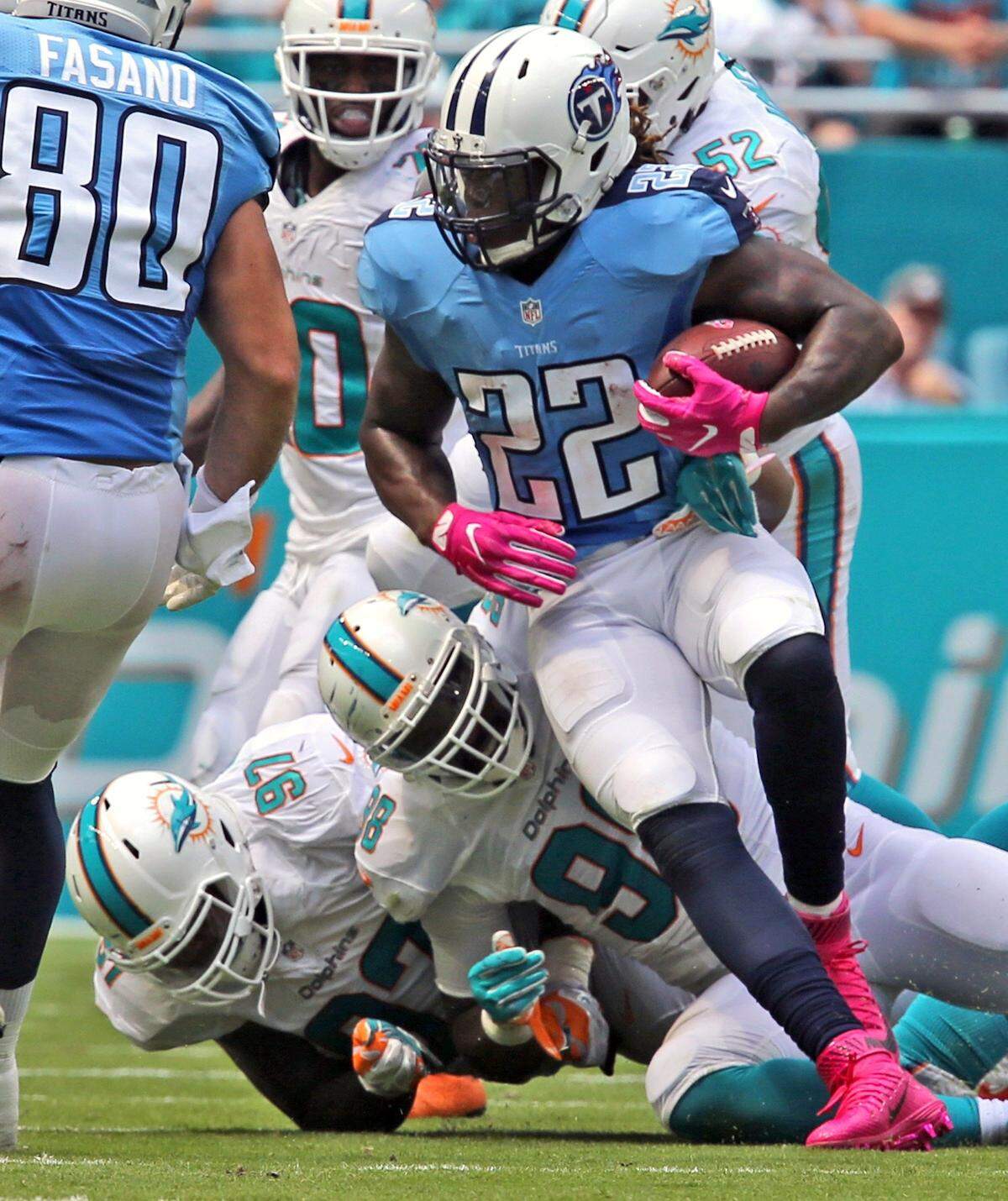 Miami Dolphins Jordan Phillips 7, and Jason Jones 98, fail to stop Tennessee Titians Derrick Henry in the third quarter at the Hard Rock Stadium in Miami Gardens, Florida, October 9, 2016.