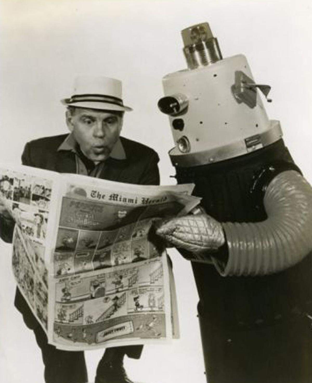 Charlie Baxter with Charlie Folds as Toby the Robot reading the Miami Herald funnies.