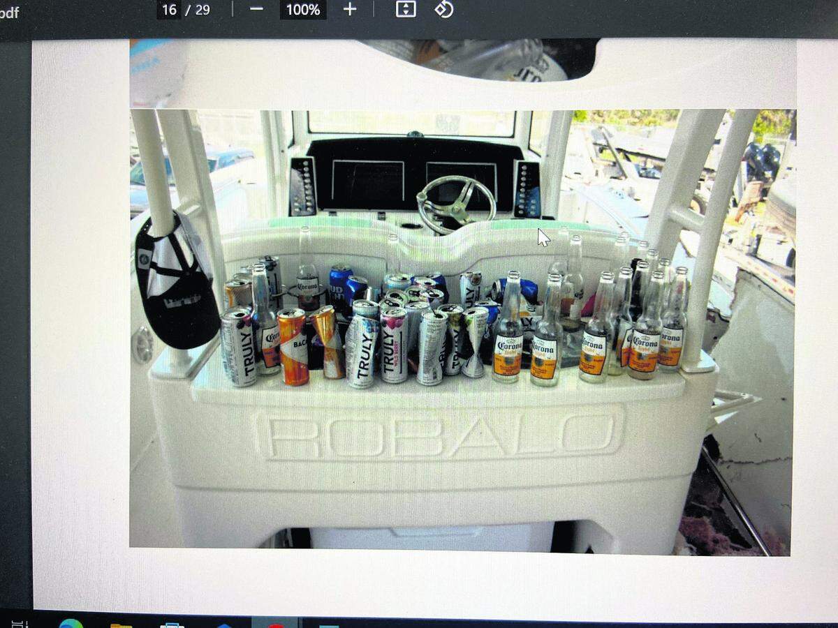 Empty beer and other alcoholic beverage bottles and cans are lined up behind the cockpit of George Pino’s 29-foot Robalo boat on Sept. 5, 2022, the day after the boat crash. FWC investigators said they found 61 empty bottles and cans of alcohol on the boat when they pulled it out of the water the day after the crash.