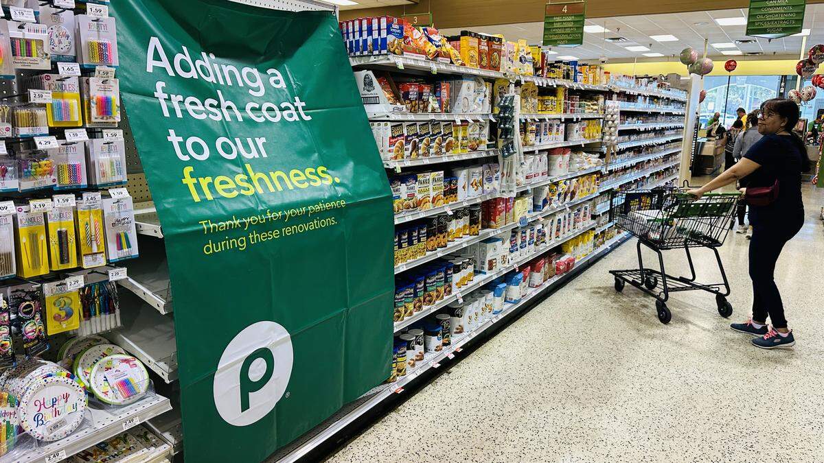 Banners draping some empty shelves inside the Palms at Town & Country mall on Jan. 10, 2026, alert customers that this store is closing on Jan. 17. A new one will be built in its place, Publix says.