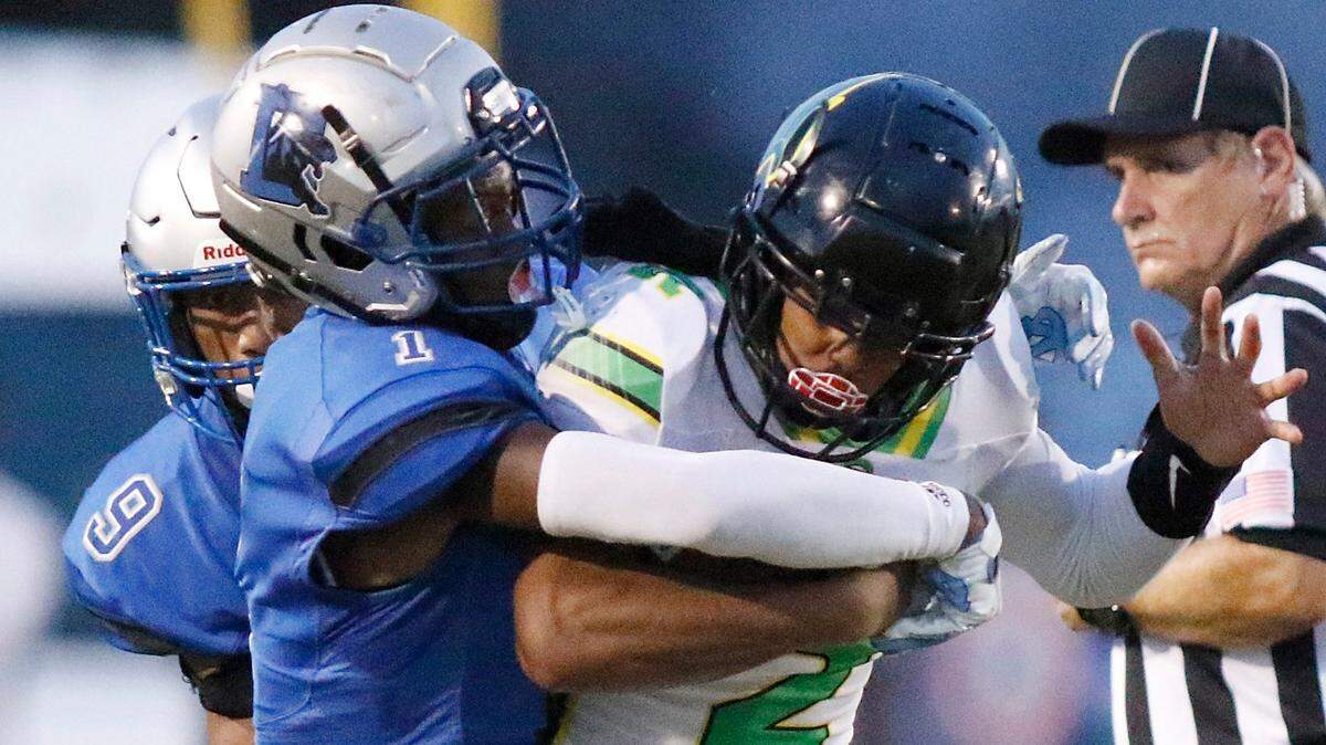 Dillard Panthers cornerback Antione Jackson (1) tackles Rock Creek Christian Academy running back Julian Marks (2) during football game on Friday, August 26, 2022 at Dillard High School in Fort Lauderdale. Andrew Uloza / for Miami Herald