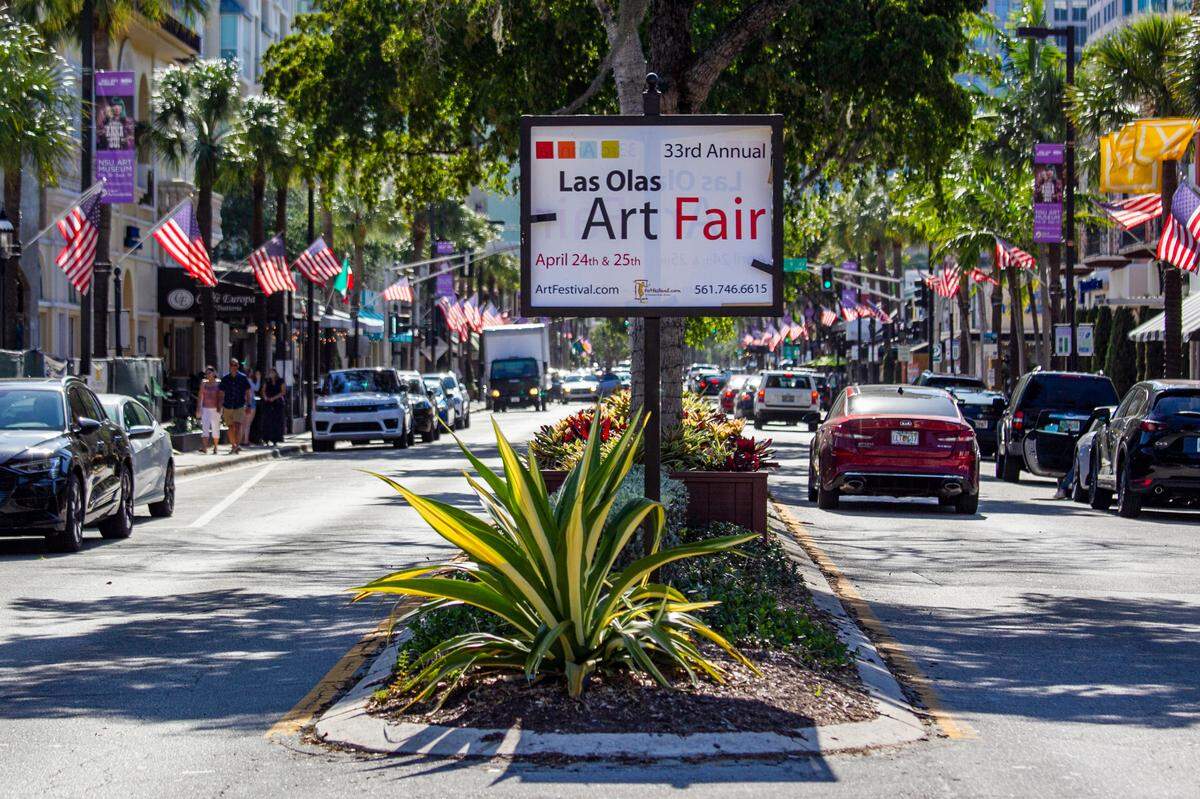 The Las Olas Boulevard, pictured above, attracts pedestrians throughout the year for its wide selection of retailers, restaurants and cafes. Above: Cars make their way down East Las Olas Boulevard in Fort Lauderdale, Florida on Monday, April 26, 2021.