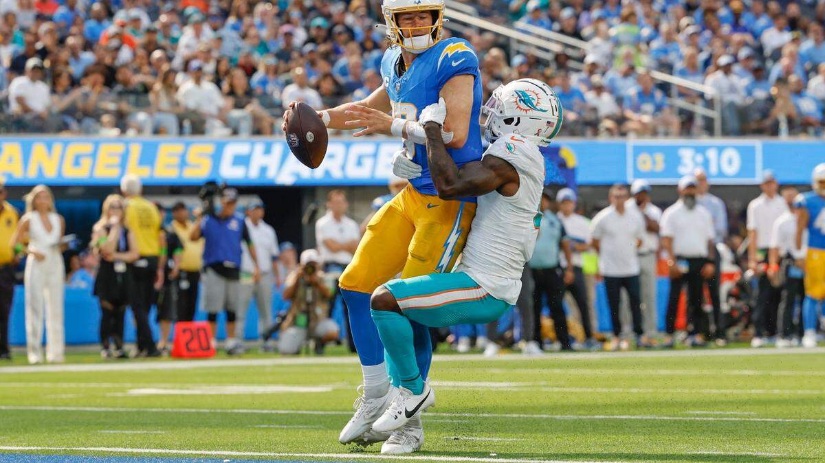 Miami Dolphins cornerback Kader Kohou (4) sacks Los Angeles Chargers quarterback Justin Herbert (10) near the goal line in the second half at SoFi Stadium in Inglewood, California on Sunday, September 10, 2023.