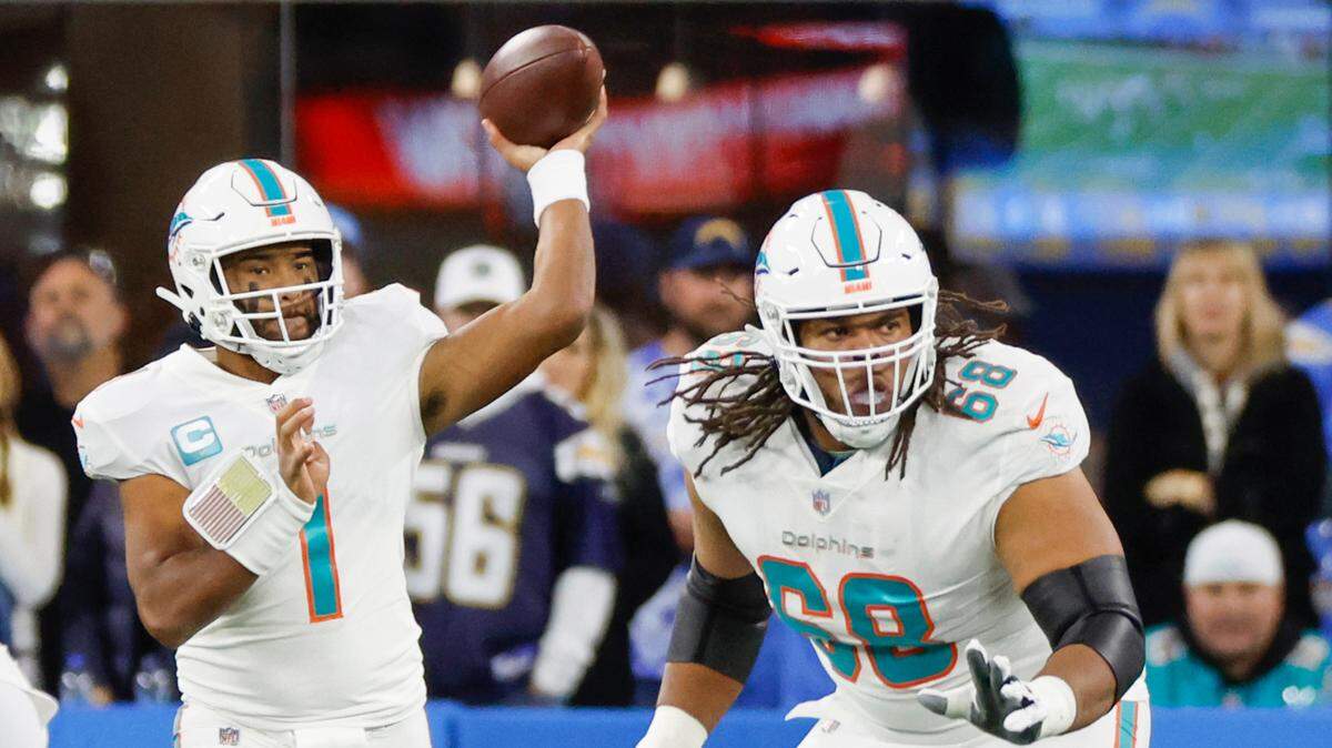 Miami Dolphins offensive tackle Robert Hunt (68) protects quarterback Tua Tagovailoa (1) in the first quarter against Los Angeles Chargers defenders at SoFi Stadium in Inglewood, California on Sunday, December 11, 2022.