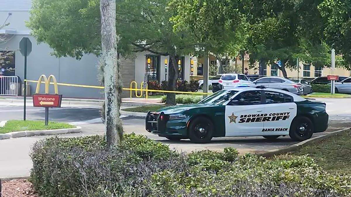 A Broward Sheriff’s Office vehicle and yellow tape are seen on the scene of a shooting south of Griffin Road on Saturday. 
