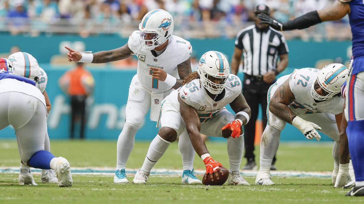 Miami Dolphins quarterback Tua Tagovailoa (1) signals at the line of scrimmage as guard Aaron Brewer (55) prepares to snap the ball in the first half against the Buffalo Bills of an NFL football game at Hard Rock Stadium in Miami Gardens, Florida on Sunday, November 9, 2025.