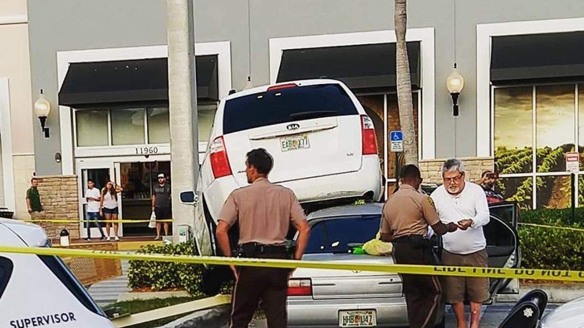 How the bleep did this van end up on top of that car at a Total Wine in Florida?