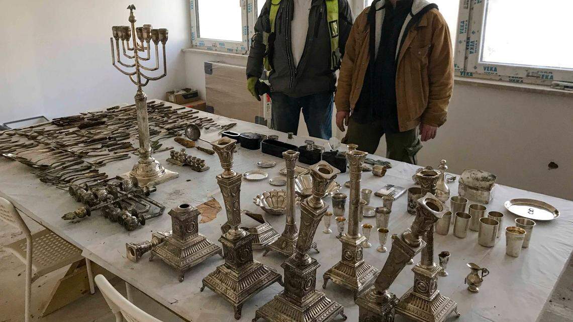 Archaeologists and construction workers in Lodz, Poland, found hundreds of silver items hidden near a former Jewish ghetto. Photos show the findings.