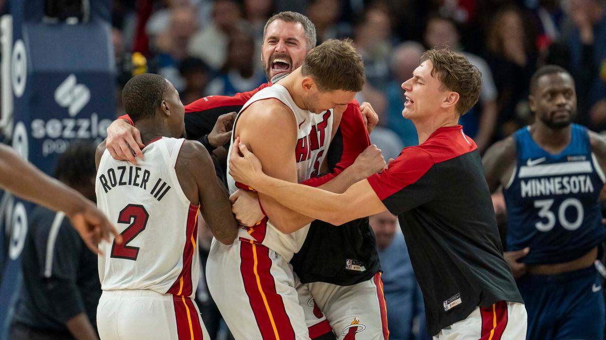 Miami Heat forward Nikola Jovic (5) (middle) celebrates with teammates after defeating the Minnesota Timberwolves at Target Center.
