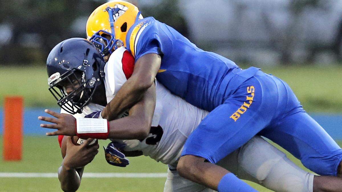 Northwestern's Samuel Brooks (1) sacks American's quarterback Tyree Bibby in the first quarter during American High School vs Northwestern High School football game at Traz Powell Stadium on Saturday, August 27, 2016.