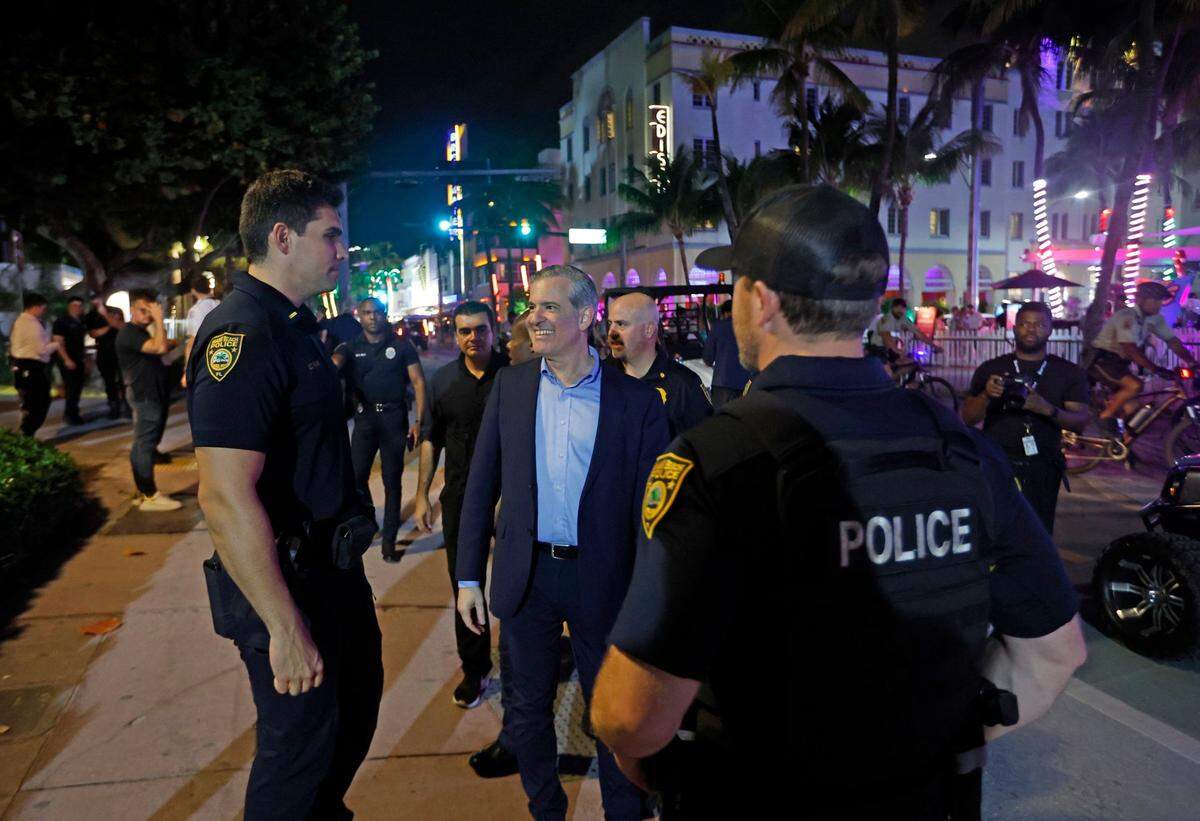 Miami Beach Mayor Steven Meiner visits with police officers on Ocean Drive during spring break in Miami Beach, Florida, on Saturday, March 9, 2024.