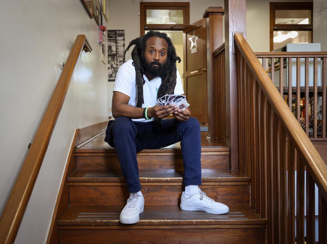 Sitting inside the Old Dillard Museum, Emmanuel George holds a deck of Black Broward flashcards that he is launching to celebrate and educate about the county’s rich Black history.
