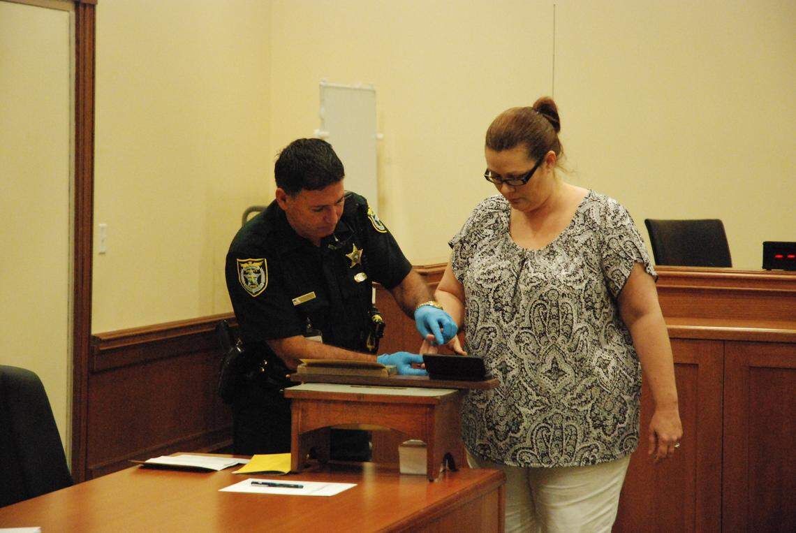 Monique Acevedo, the wife of the former schools superintendent of Monroe County, is fingerprinted during her sentencing hearing in Key West on Aug. 31, 2010. She pleaded guilty to six felony counts of stealing $413,000 from the Monroe County School District, and was sentenced to eight years in prison.
