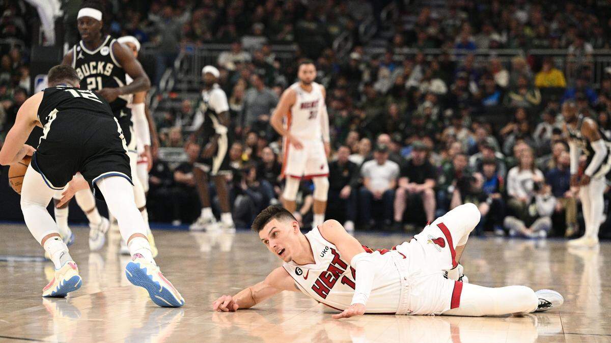 Miami Heat guard Tyler Herro (14) injures his hand while diving for a loose ball against the Milwaukee Bucks during game one of the 2023 NBA Playoffs at Fiserv Forum.