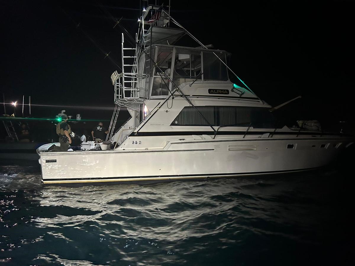 A large Bertram fishing boat floats off the coast of Fort Pierce Wednesday, Feb. 22, 2023. U.S. Customs officials said 78 people from Haiti were on board the vessel.