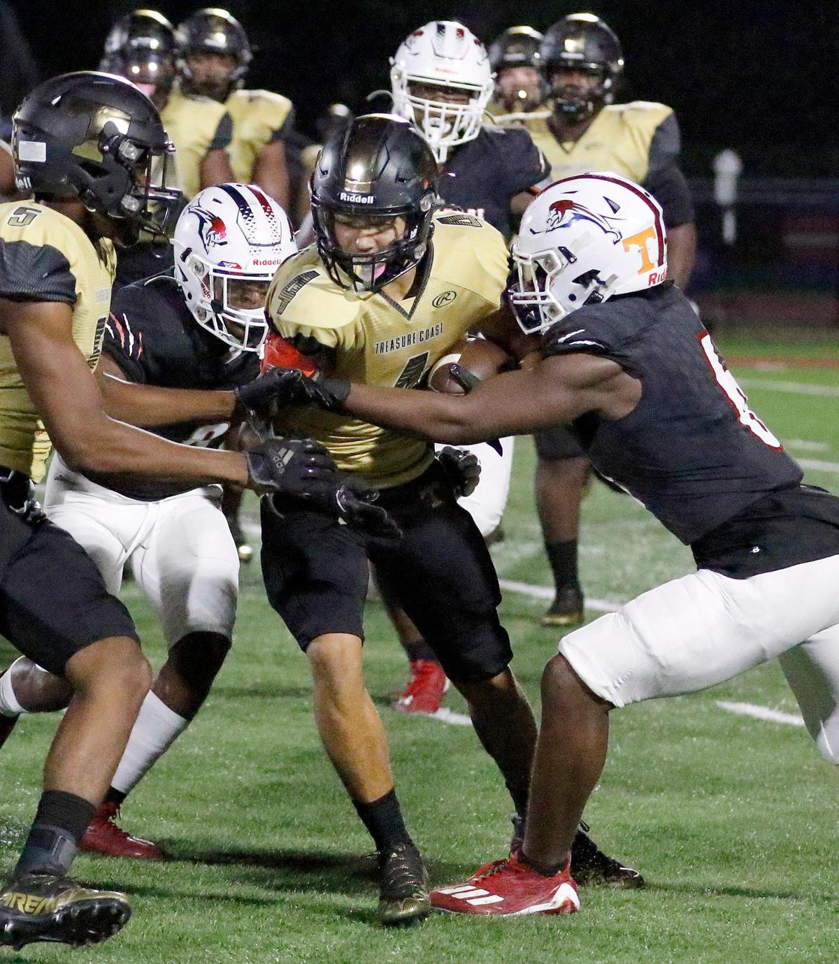 Chaminade-Madonna Lions defenders tackle Treasure Coast Titans George Roberts during the football game on Thursday, November 3, 2022 at Chaminade-Madonna HS in Holliwood. Andrew Uloza / for Miami Herald