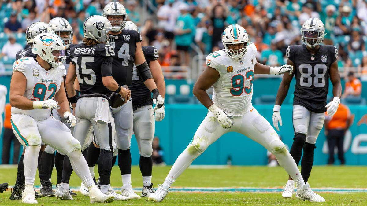 Miami Dolphins defensive tackle Calais Campbell (93) and teammate Dolphins defensive tackle Zach Sieler (92) react after sacking Las Vegas Raiders quarterback Gardner Minshew (15) in the second half of their NFL game at Hard Rock Stadium on Sunday, Nov. 17, 2024, in Miami Gardens, Fla