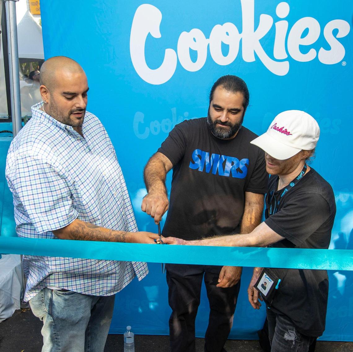 Cookies founder Berner, left, AK, TRP Head of Cultivation, center, and Marcus Moates, TRP Head of Extraction, left, participate in the ribbon cutting ceremony during the grand opening of Cookies Miami, Florida’s first and only minority-owned marijuana dispensary, in Miami on Saturday, Aug. 13, 2022.