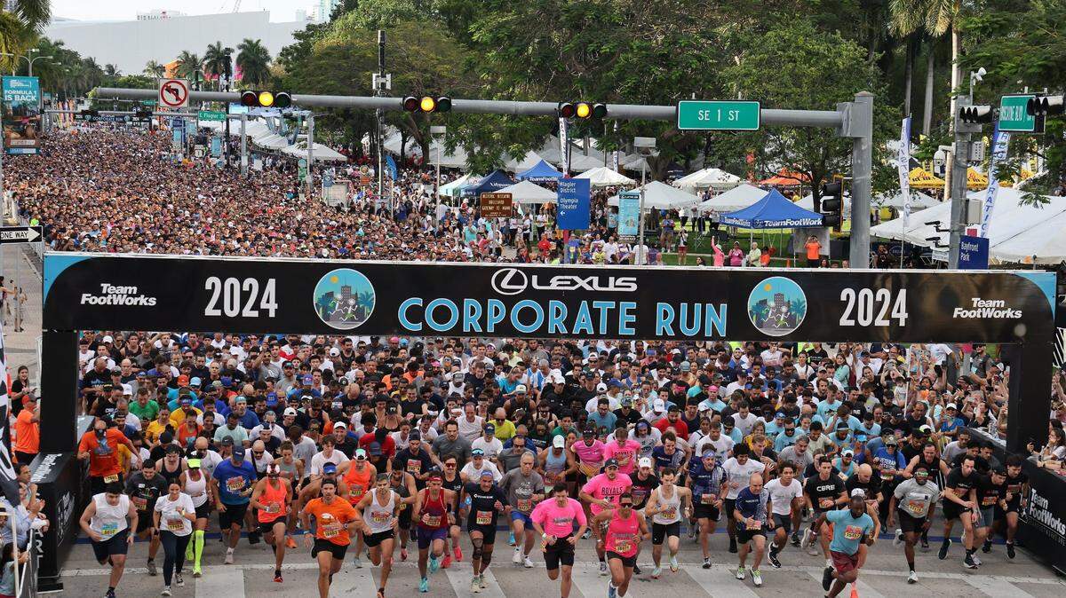 Runners take off from the starting line in front of Bayfront Park on Biscayne Boulevard heading south. The annual 5K race is referred to as “South Florida’s Largest Office Party” with over seventeen thousand registered runners and hundreds of companies represented.