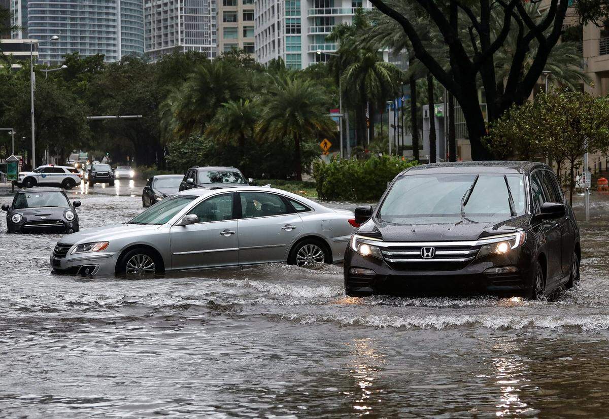 Vehicles navigate around immobile motorists as Tropical Storm Eta slammed into Miami, leaving drivers crossing the intersection of Southwest 13th Street and Brickell Avenue stuck in floodwater on Nov. 9, 2020.
