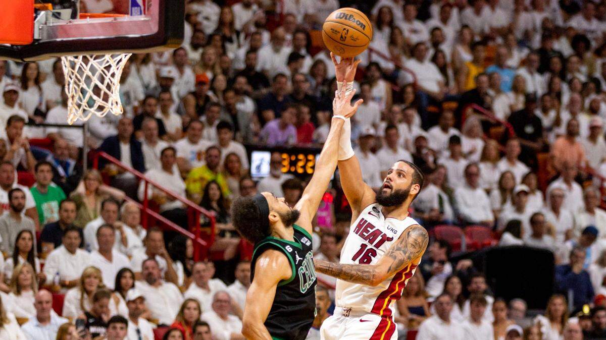 Miami Heat forward Caleb Martin (16) shoots over Boston Celtics point guard Derrick White (9) during the first half of Game 3 of the NBA Eastern Conference Finals series at Kaseya Center in Miami on May 21, 2023.