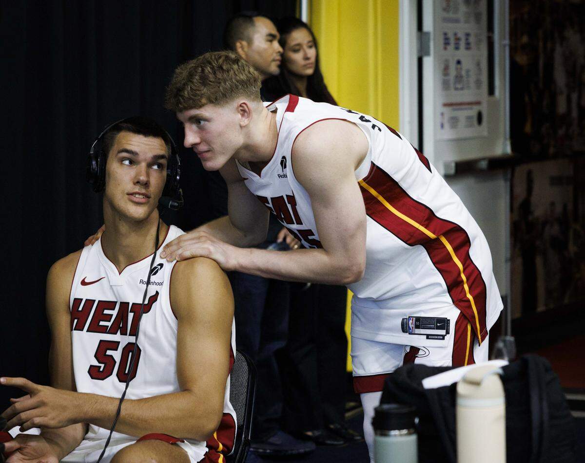 Kasparas Jakucionis (25) checks in on Vladislav Goldin (50) during an interview during the Miami HEAT Media Day on Monday, Sept. 29, 2025, at the Kaseya Center in downtown Miami, Fla.