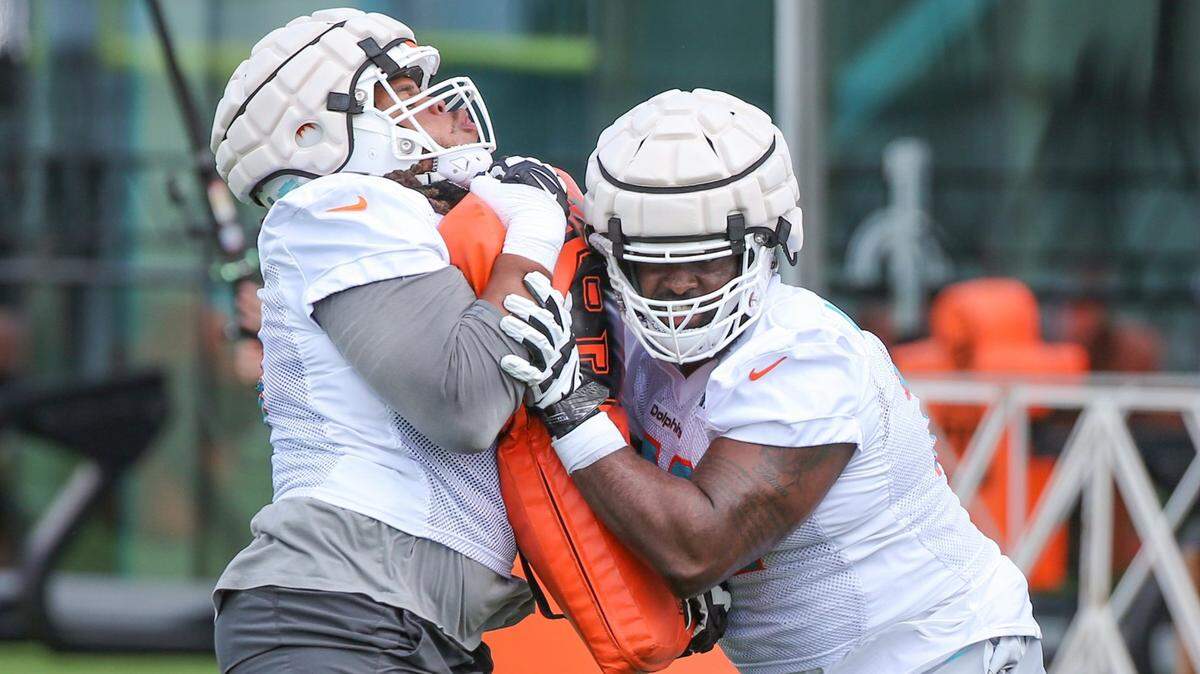 Miami Dolphins tackle Terron Armstead (72) and offensive lineman Robert Hunt (68) run drills during practice at Baptist Health Training Complex in Miami Gardens on Friday, July 29, 2022.
