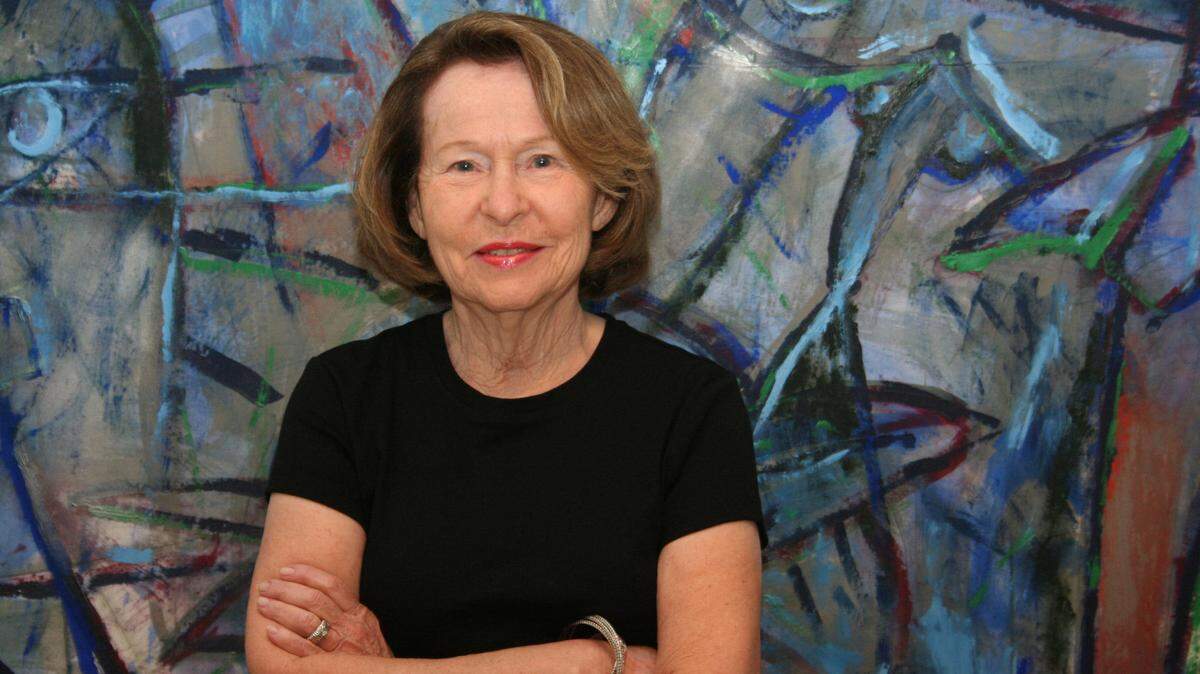 Rosa De La Cruz in front of one of the Carlos Alfonzo works on display at the De La Cruz Collection.