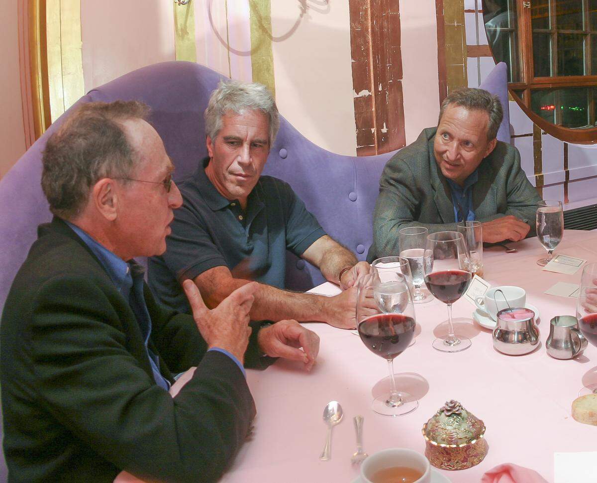 On Sept. 9, 2004, Jeffrey Epstein, center, hosted a dinner at Harvard University. With Epstein are Alan Dershowitz, foreground, and Lawrence Summers, the former treasury secretary and Harvard president.