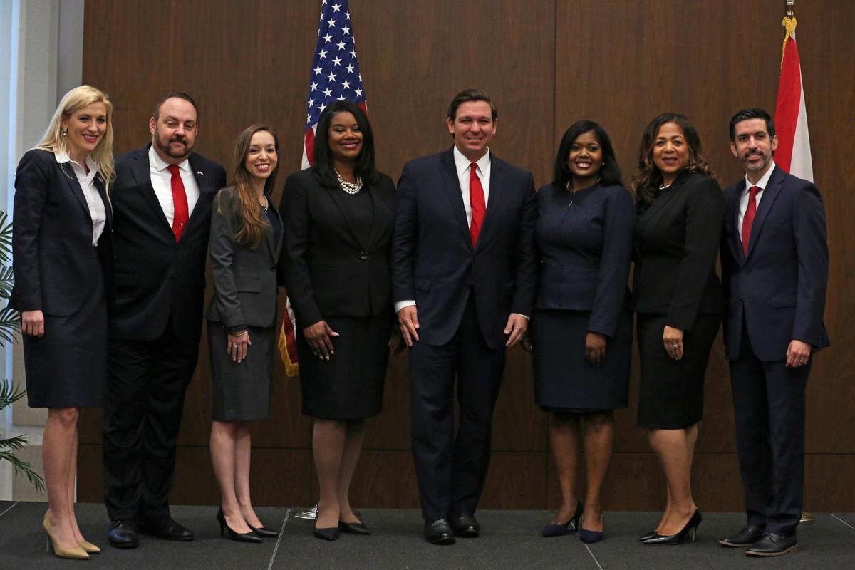 Florida Gov. Ron DeSantis, center, poses with the seven recently appointed judges to Miami Dade County and the 11th Circuit at the Otto G. Richter Library at the University of Miami in Coral Gables, Florida, on Monday, December 16, 2019.