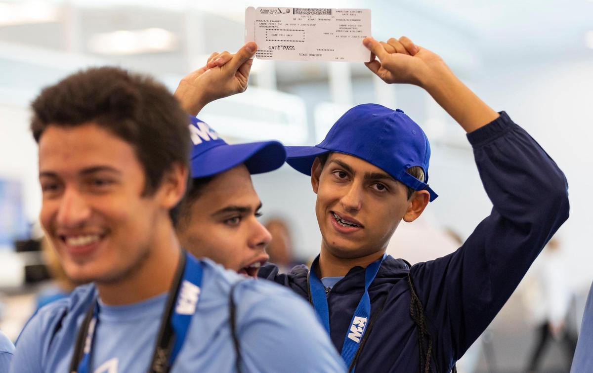 Alexander Peraza, 18, shows his boarding pass during the MIAair tour at the Miami International Airport on Monday, Oct. 23, 2023, in Miami, Fla. The MIA Airport Instruction and Readiness tour allows more than 30 children with special needs to walk through an airport travel experience from start to finish in a safe and controlled environment.