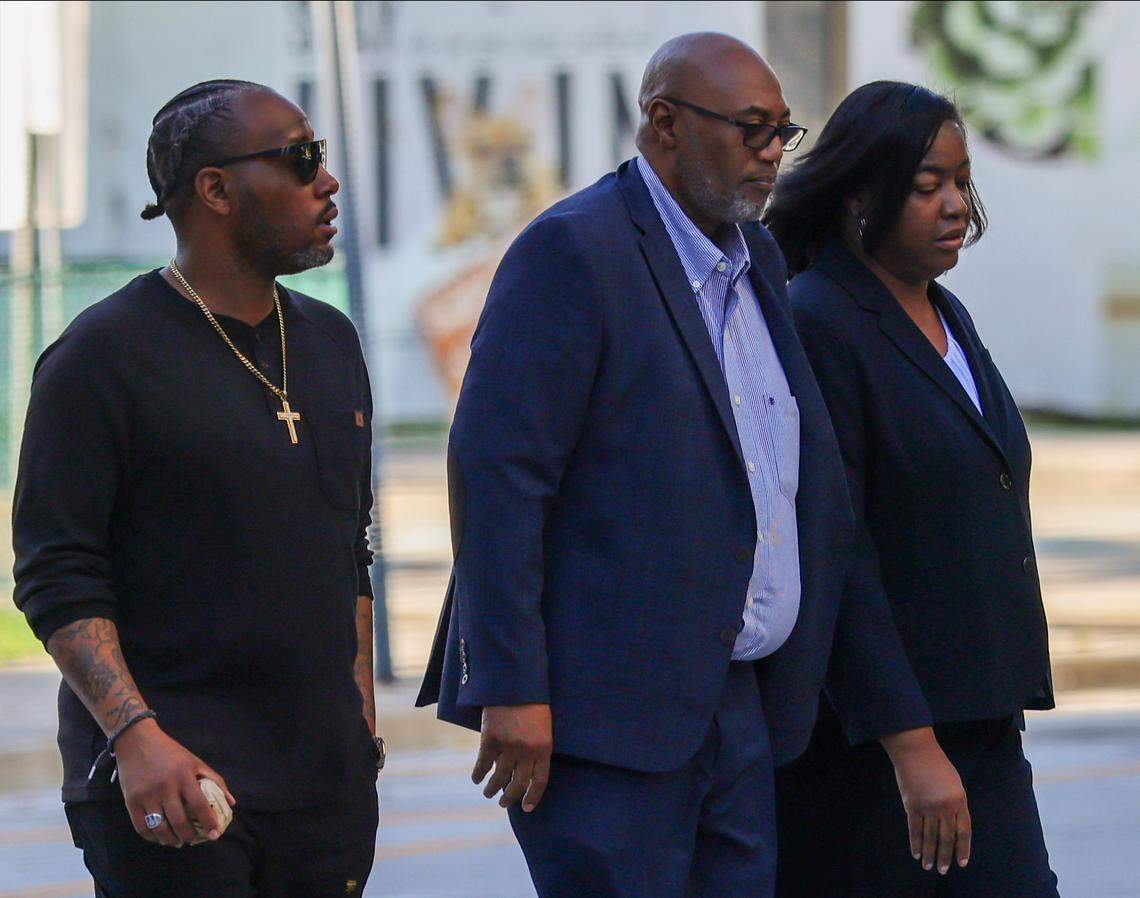 An unidentified man, left, escorts Arthur Gatlin and his wife Charmaine Gatlin, right, the former chief operating officer of the Jackson Health Foundation, for sentencing at Wilkie D. Ferguson Jr. Courthouse on Wednesday, December 10, 2025, in Miami, Florida.