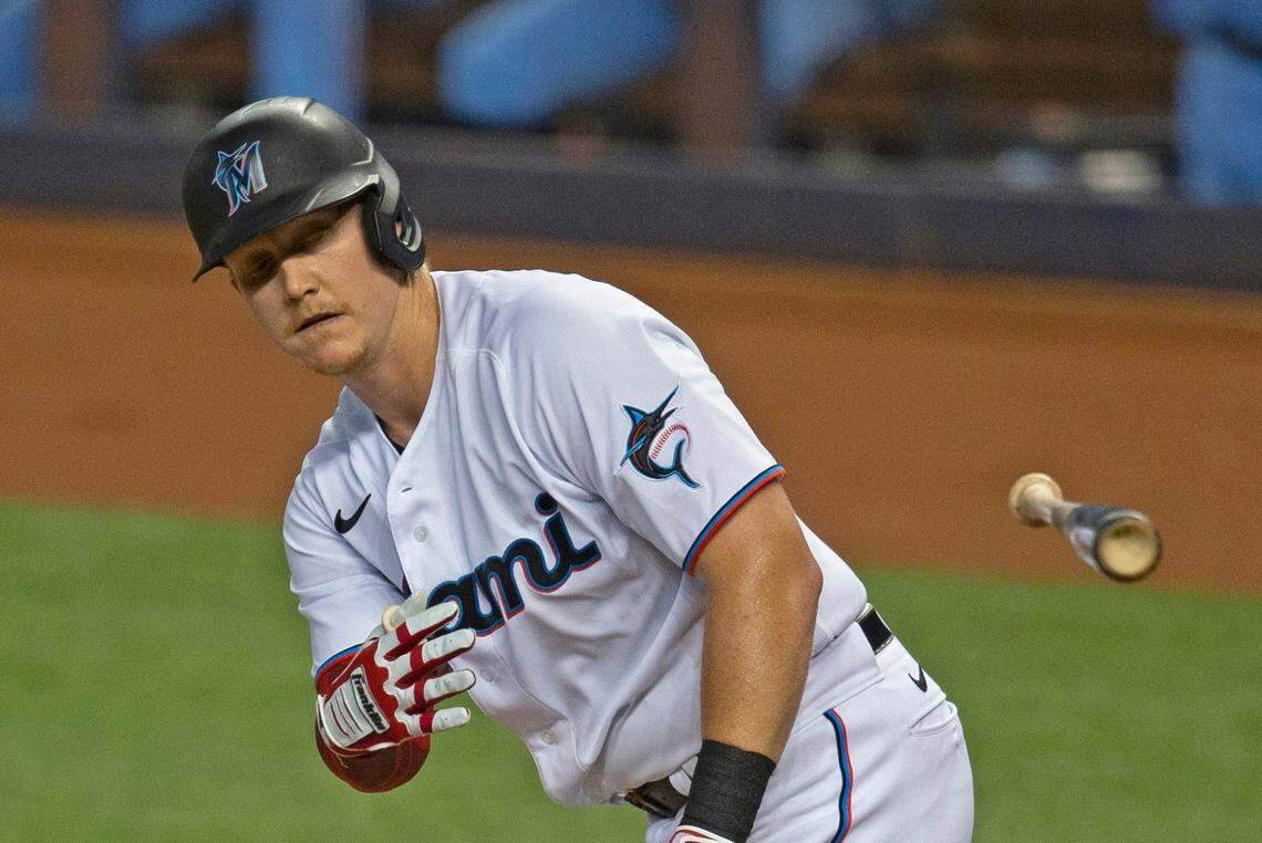 Miami Marlins first baseman Garrett Cooper (26) throws the bat after being walk by Toronto Blue Jays pitcher Hyun Jin Ryu during the first inning of a baseball game at at Marlins Park in Miami on Wednesday, September 2, 2020.