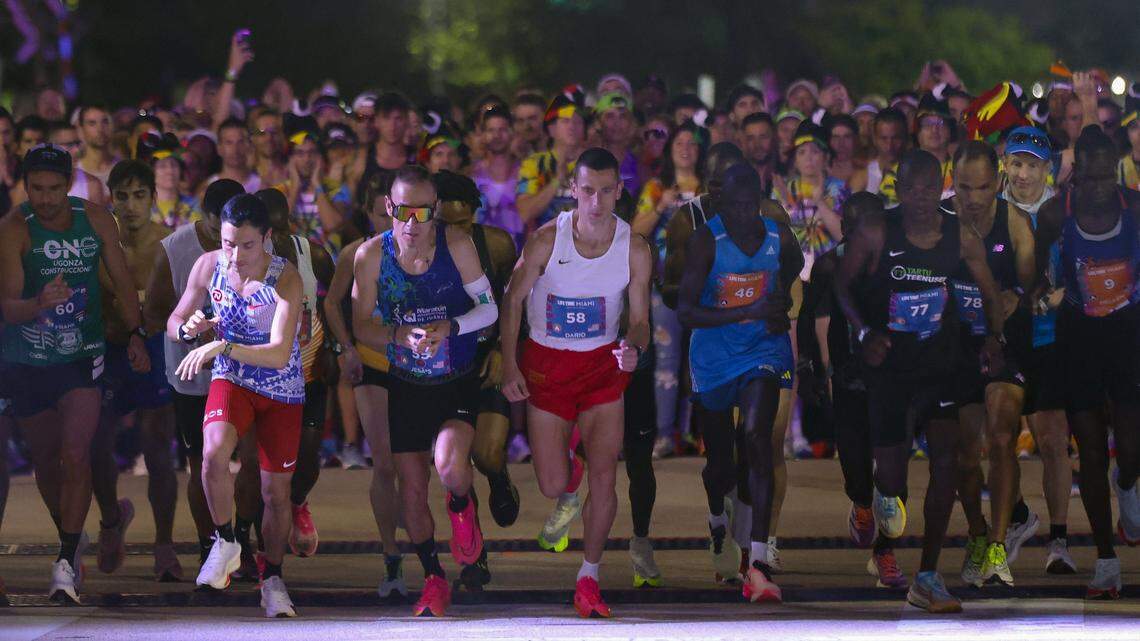 Elite runners leave the starting line in front of the Kaseya Center during the start of the Life Time Miami Marathon on Sunday, January 28, 2024 in Miami, Florida