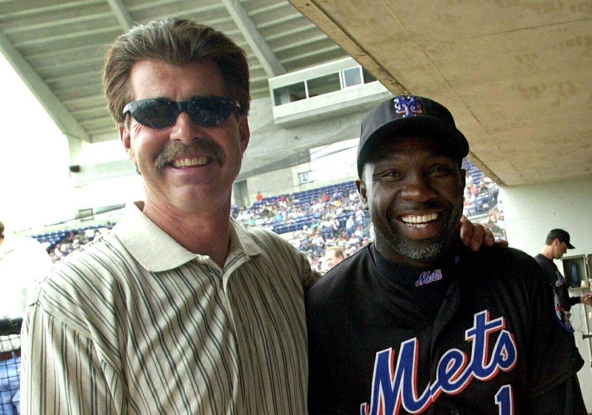 New York Mets coach Mookie Wilson poses with former Boston Red Sox player Bill Buckner in Port St. Lucie, Fla. Buckner, a star hitter who became known for making one of the most infamous plays in major league history, has died. He was 69. Buckner’s family said in a statement that he died Monday, May 27, 2019, after a long battle with dementia.