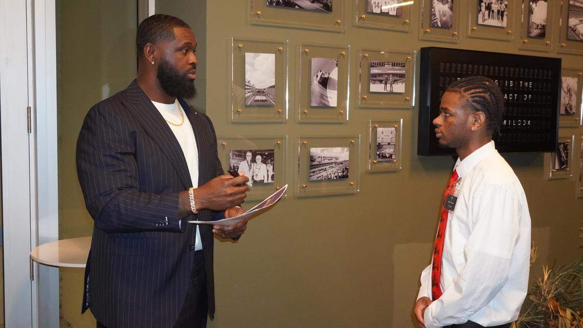 Miami Dolphins tackle Terron Armstead talks to a student at his “I Am a Business” pitch competition at Hard Rock Stadium in Miami Gardens, Florida on Friday, January 10, 2025. The program allowed students to pitch their business ideas for a chance at a $1,000 prize.