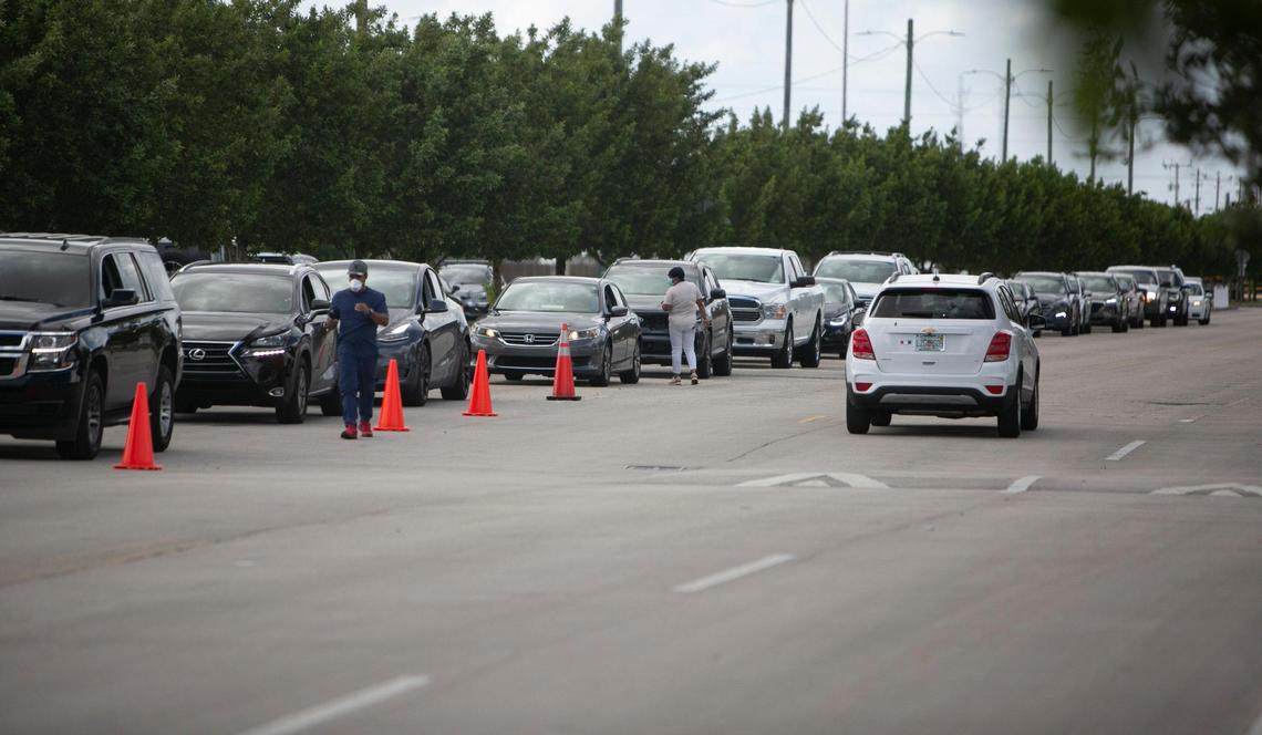 Cars line up for free COVID-19 testing at Miami-Dade College’s North campus Friday afternoon, Dec. 17, 2021.