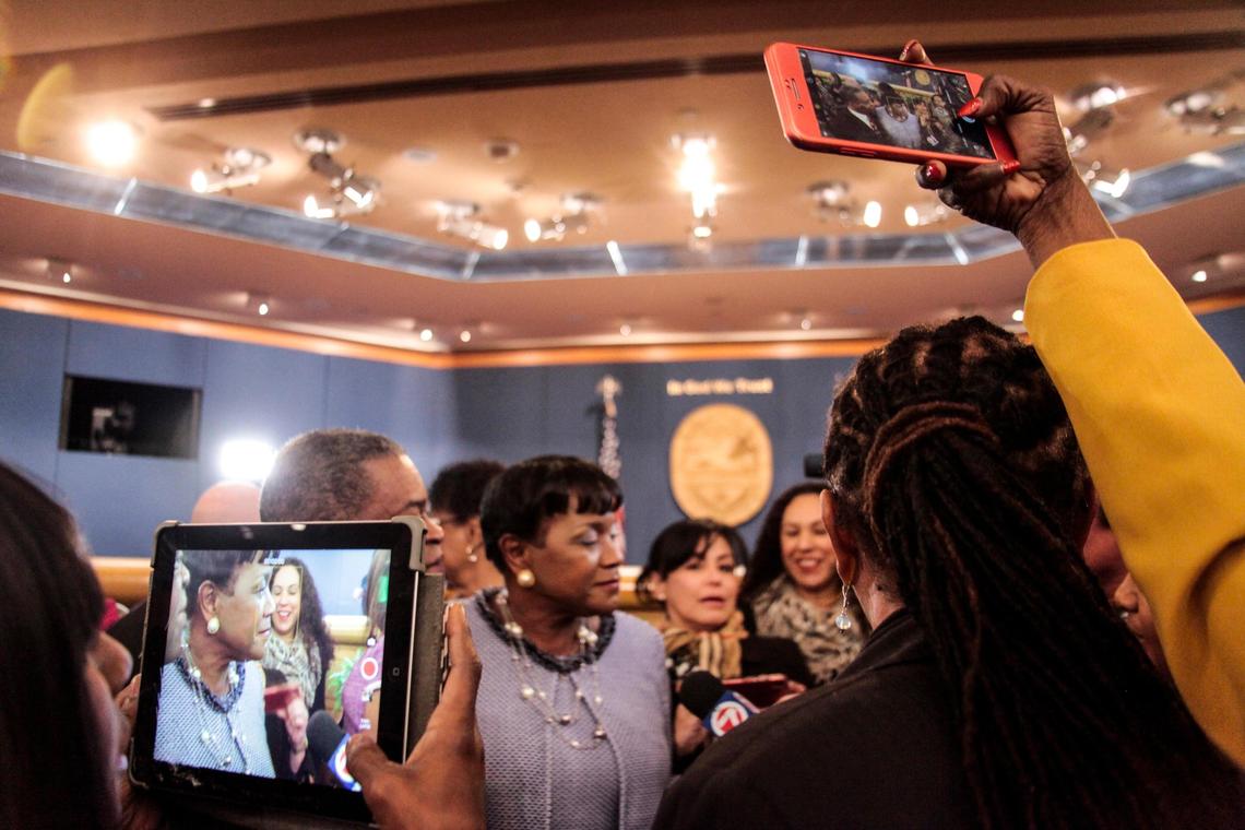 Audrey Edmonson, Miami-Dade’s District 3 commissioner, speaks to reporters while community members take videos and photos after her installation as chairwoman of the 13-seat board on Friday, Jan. 11, 2019.