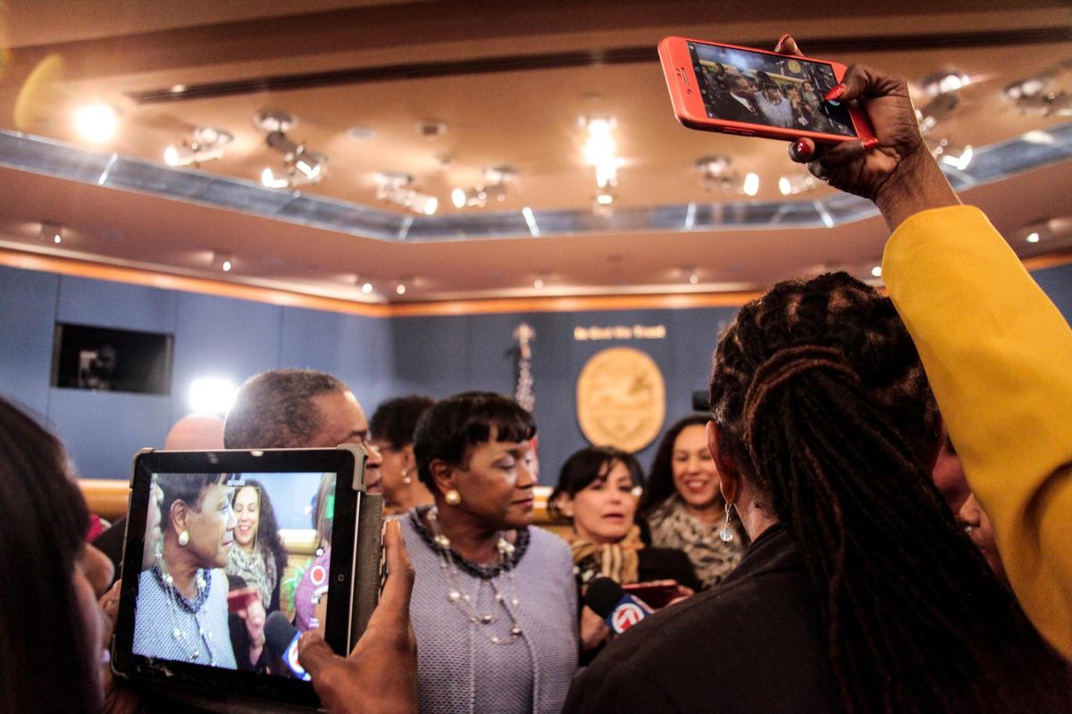 Audrey Edmonson, Miami-Dade’s District 3 commissioner, speaks to reporters while community members take videos and photos after her installation as chairwoman of the 13-seat board on Friday, Jan. 11, 2019.