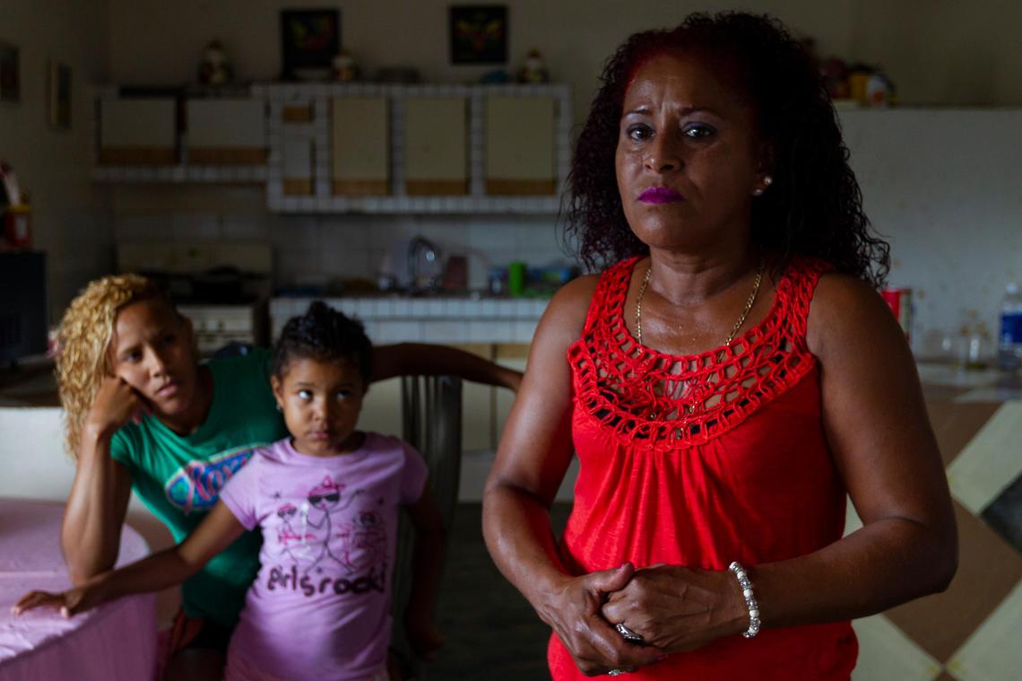Merry Perez Colon, 51, her daughter Yeisha Zayas Perez, 27, and her granddaughter, Nathanais Kamila Reyes Zayas, 5, live in a hurricane damaged home in La Juncia community in Comero, Puerto Rico on August, 25, 2018. Perez Colon, whose husband is disabled, is repairing the home herself after the family was denied federal disaster aid.
