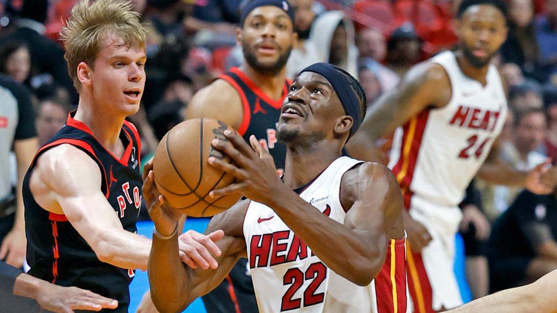 Miami Heat forward Jimmy Butler (22) attempts a basket as Toronto Raptors guard Gradey Dick (1) defends in the second quarter during the regular-season finale for the Heat at the Kaseya Center, Miami, Florida on Sunday, April 14, 2024.
