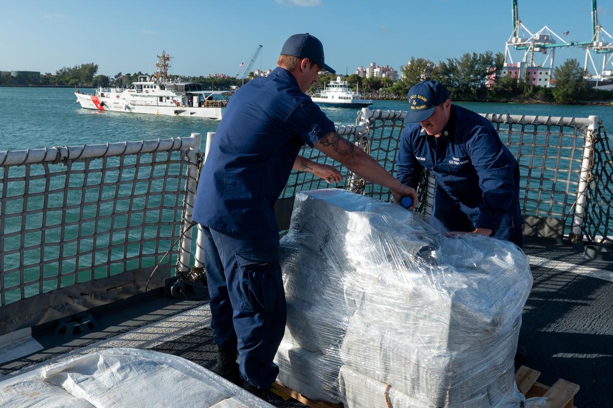 Crew members from U.S. Coast Guard Cutter Valiant uses plastic wrap to bind captured cocaine at Base Miami Beach, Florida, Thursday, Mar. 6, 2025. The Valiant’s crew secured the illegal drugs after six interdictions in the international waters of the Caribbean.