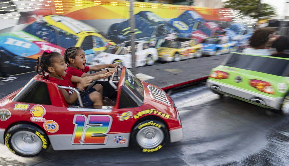 Mina On-Sang, 6, and her brother, Leo On-Sang, 4, ride the Speedway attraction during the opening day of the 74th annual Miami-Dade County Youth Fair on Thursday, March 12, 2026, in Miami, Fla.