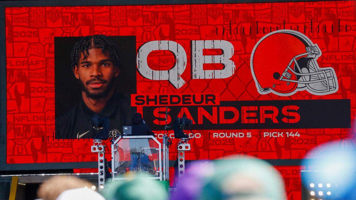 A graphic announcing Colorado quarterback Shedeur Sanders’ selection by the Cleveland Browns with the 144th overall pick is seen in the Draft Theater during the third day of the 2025 NFL Draft at Lambeau Field.